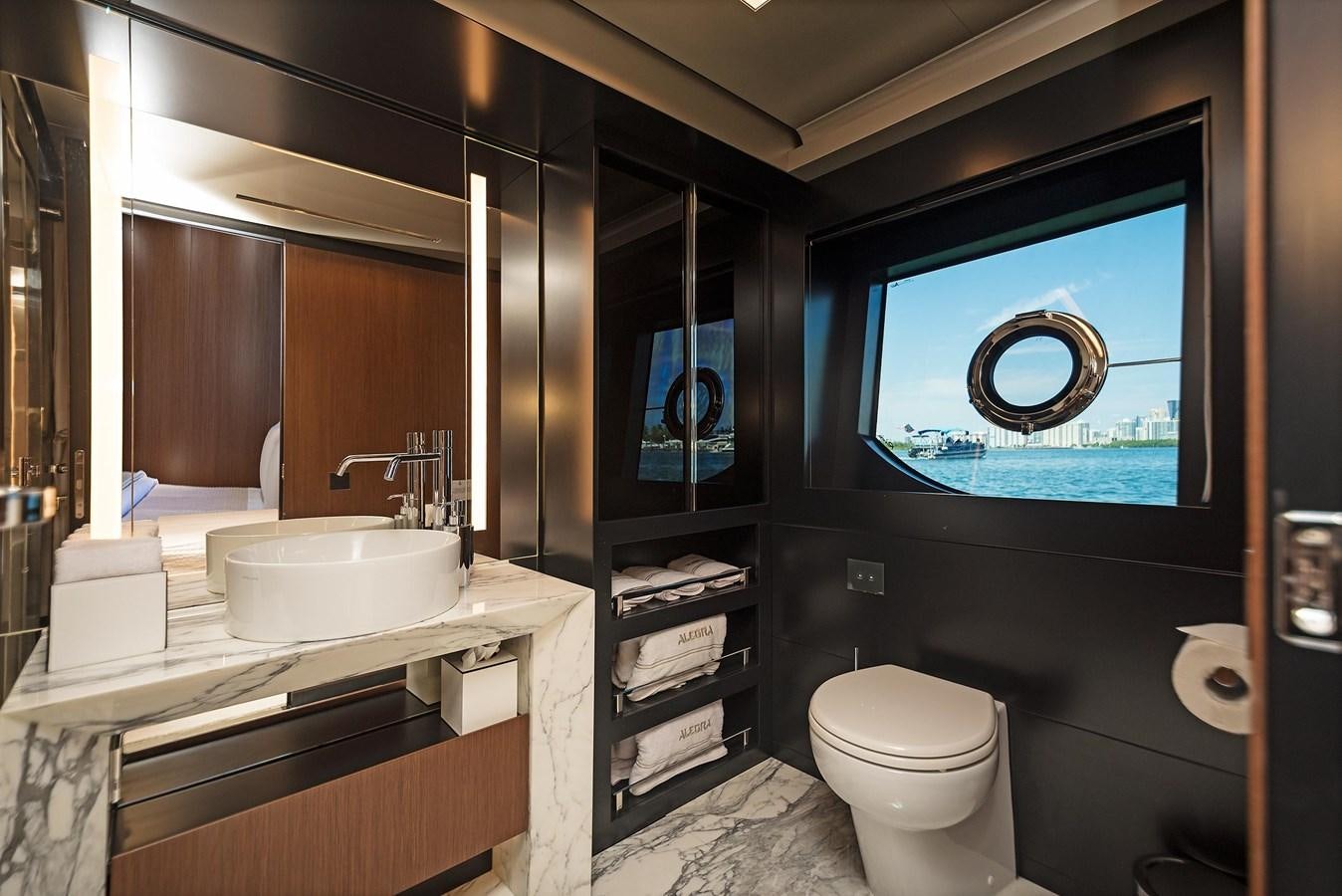 a bathroom with a sink toilet and a mirror aboard ALLEGRA  @ AVENTURA Yacht for Sale