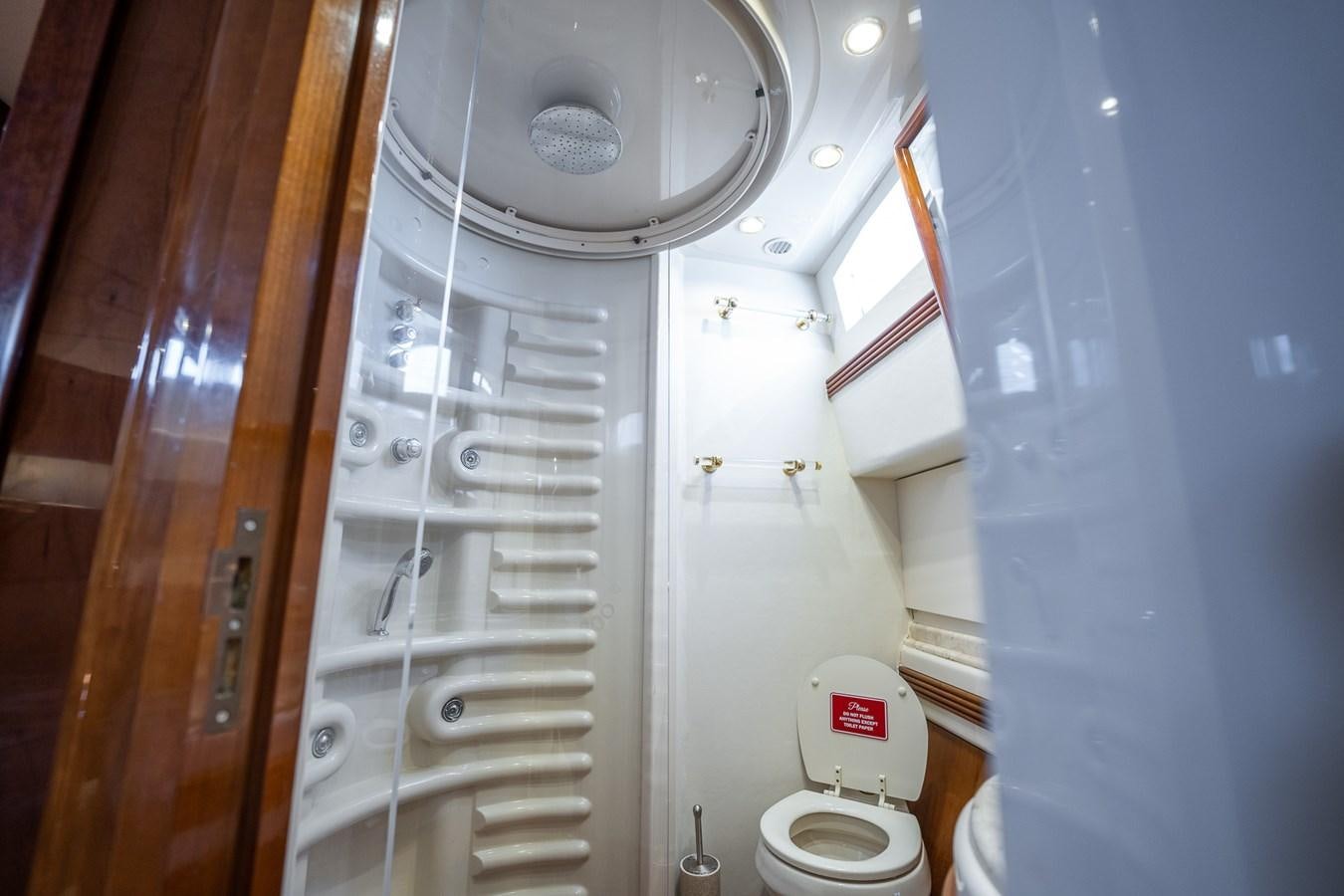 a bathroom with a toilet and shower aboard 80 CARAT Yacht for Sale