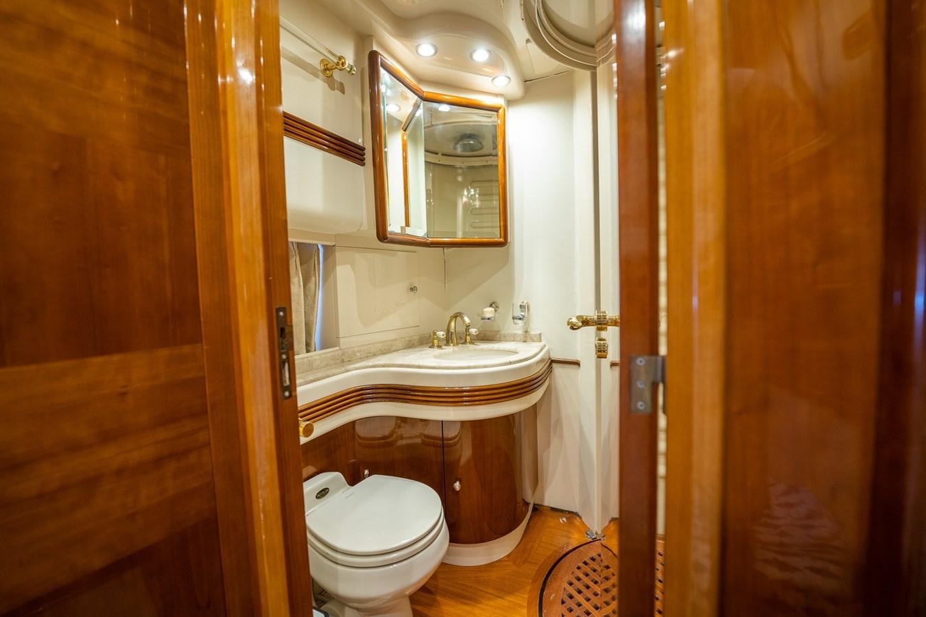 a bathroom with a sink toilet and a mirror aboard 80 CARAT Yacht for Sale