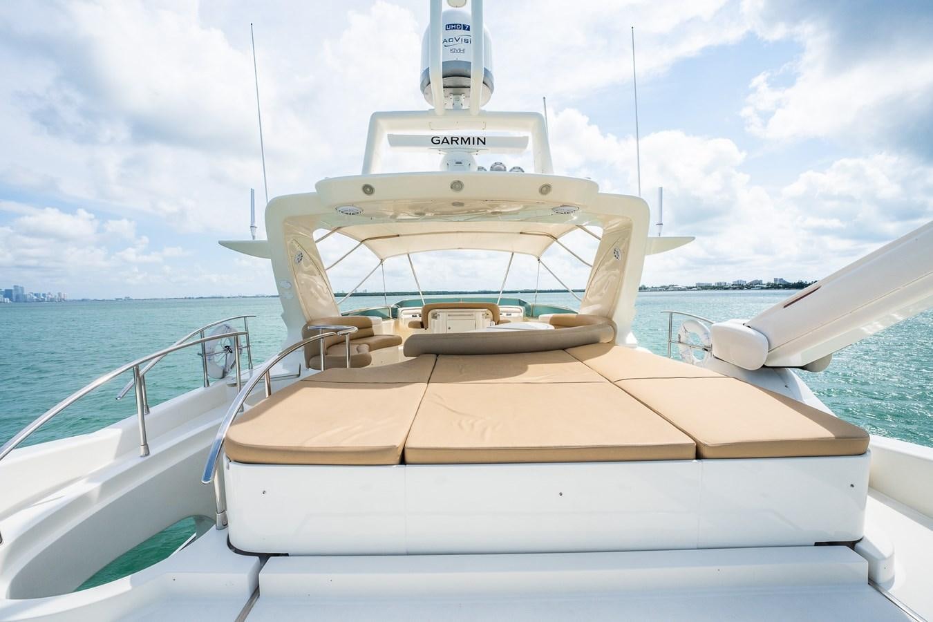 a white boat on a body of water aboard 80 CARAT Yacht for Sale