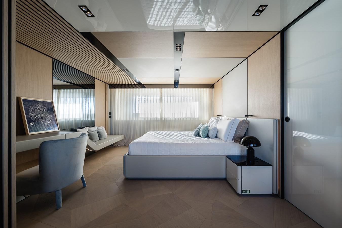 a bedroom with a bed and a chair aboard UV II Yacht for Sale