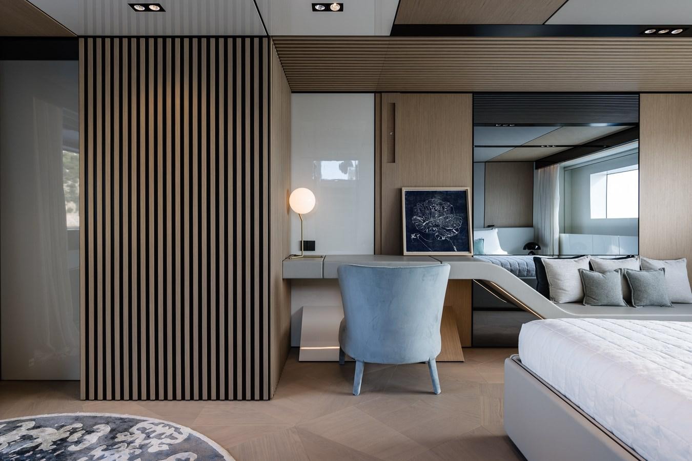 a room with a bed and a chair aboard UV II Yacht for Sale