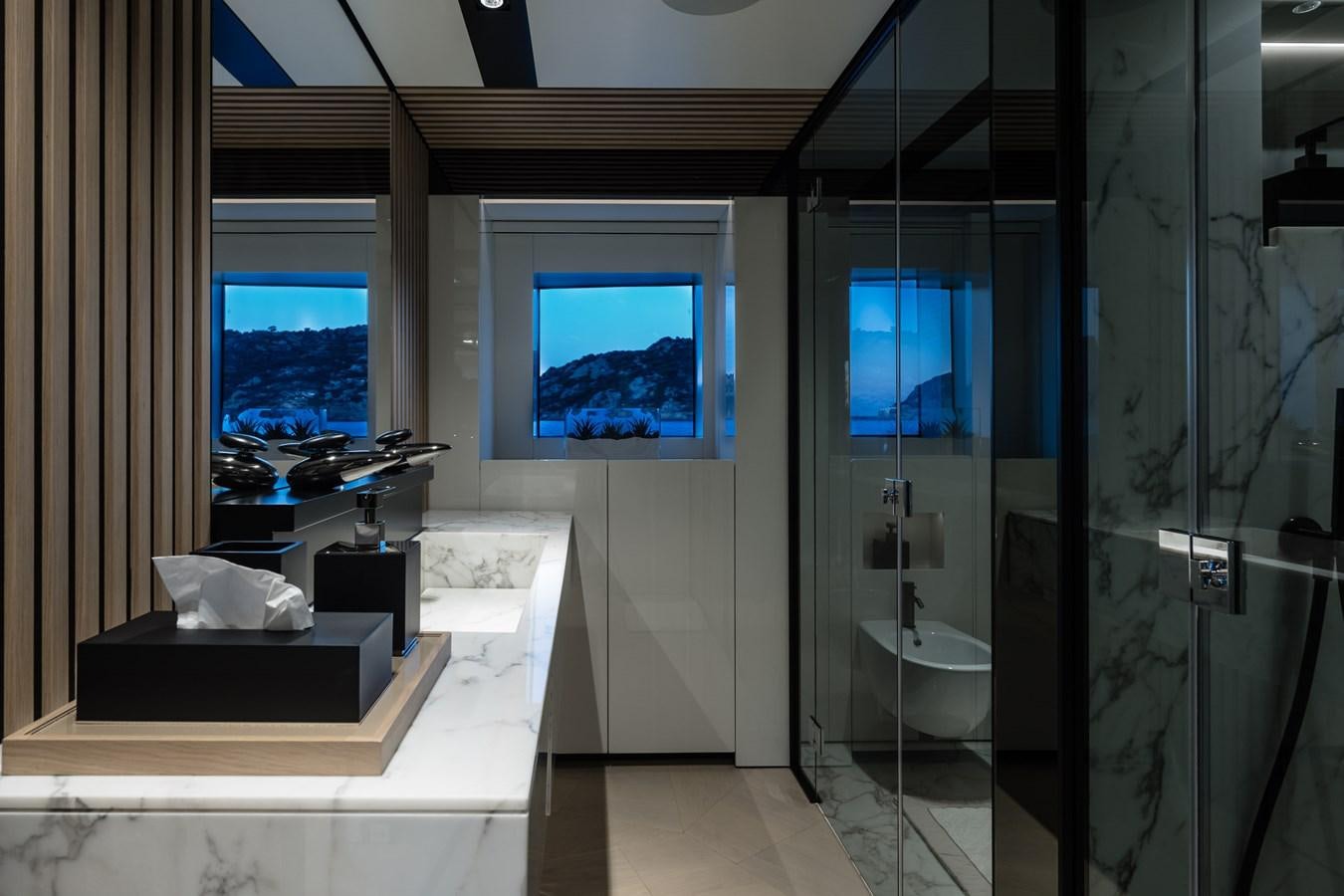 a bathroom with a glass shower aboard UV II Yacht for Sale