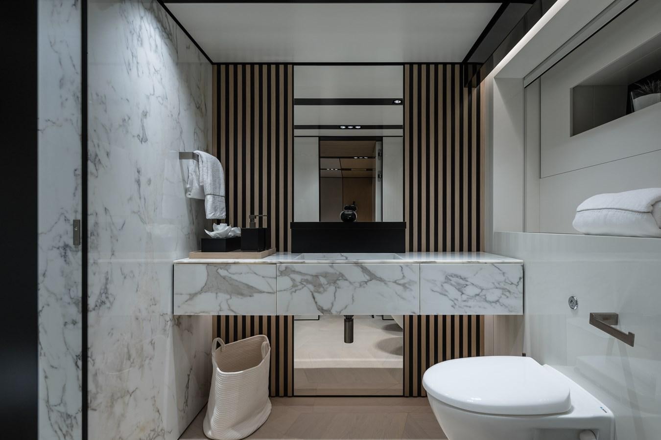 a bathroom with a tub sink and toilet aboard UV II Yacht for Sale