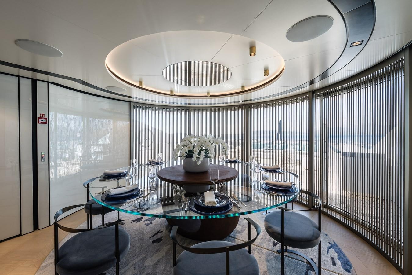 a room with a table and chairs aboard UV II Yacht for Sale