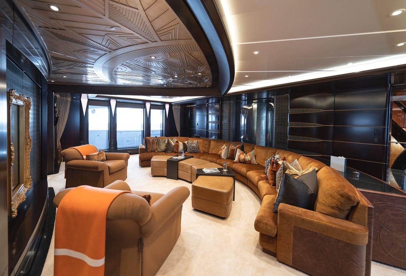 a large living room with leather couches and a large window aboard WHISPER Yacht for Sale