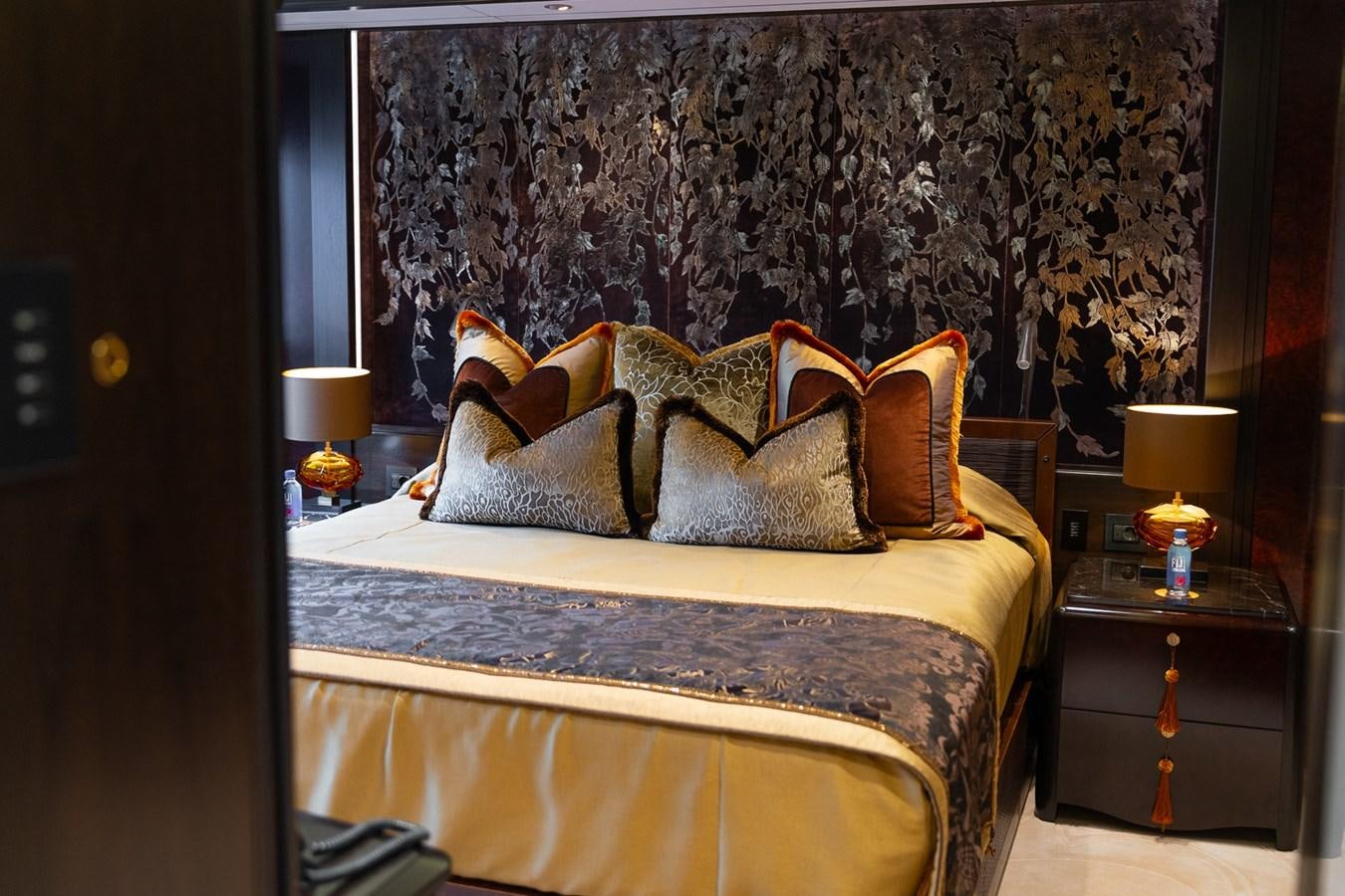 a bed with a blue comforter and pillows aboard WHISPER Yacht for Sale