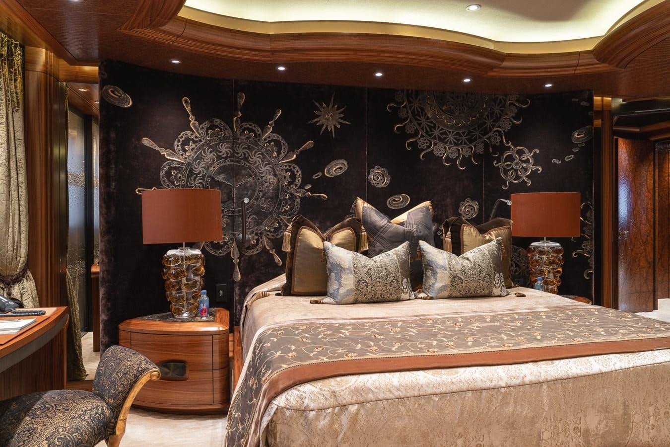 a bed with a large painting on the wall aboard WHISPER Yacht for Sale