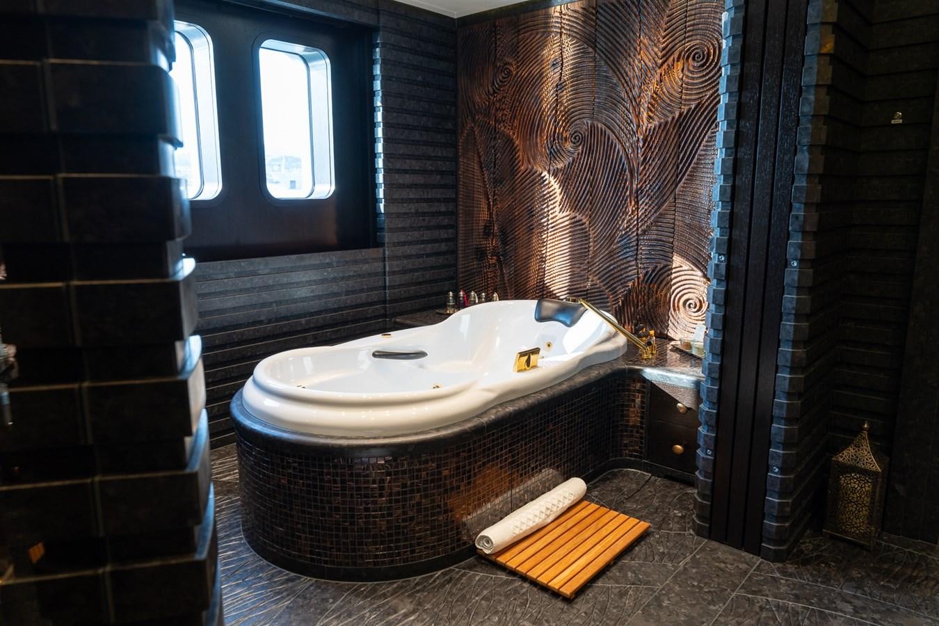 a bathroom with a tub and a sink aboard WHISPER Yacht for Sale