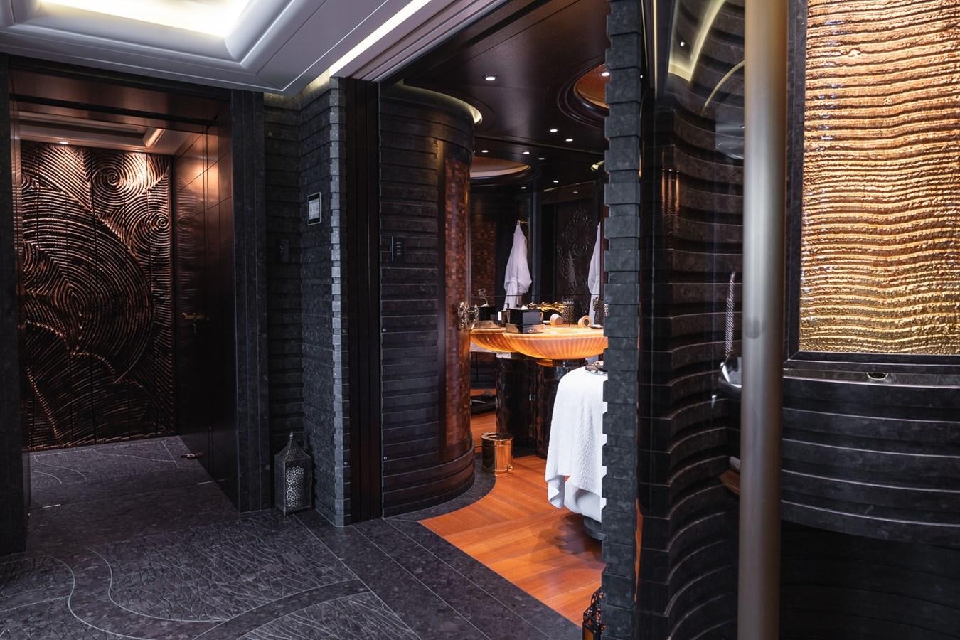 a room with black walls and a white robe from the ceiling aboard WHISPER Yacht for Sale