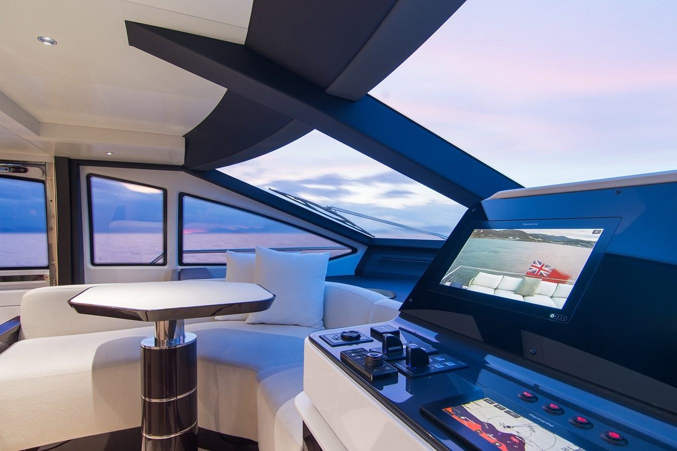 a room with a table and a tv aboard GDL Yacht for Sale