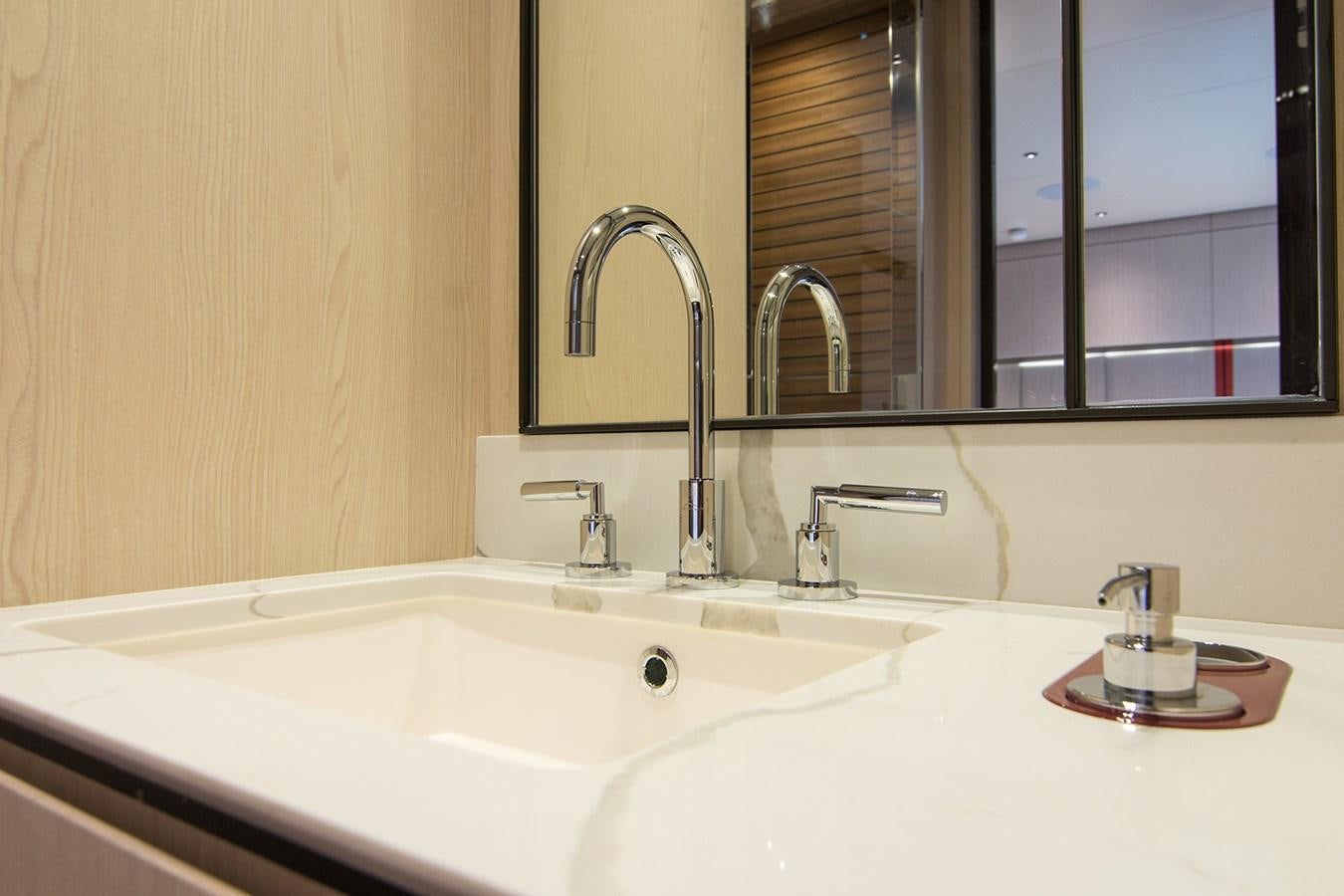 a bathroom sink with a large mirror aboard GDL Yacht for Sale