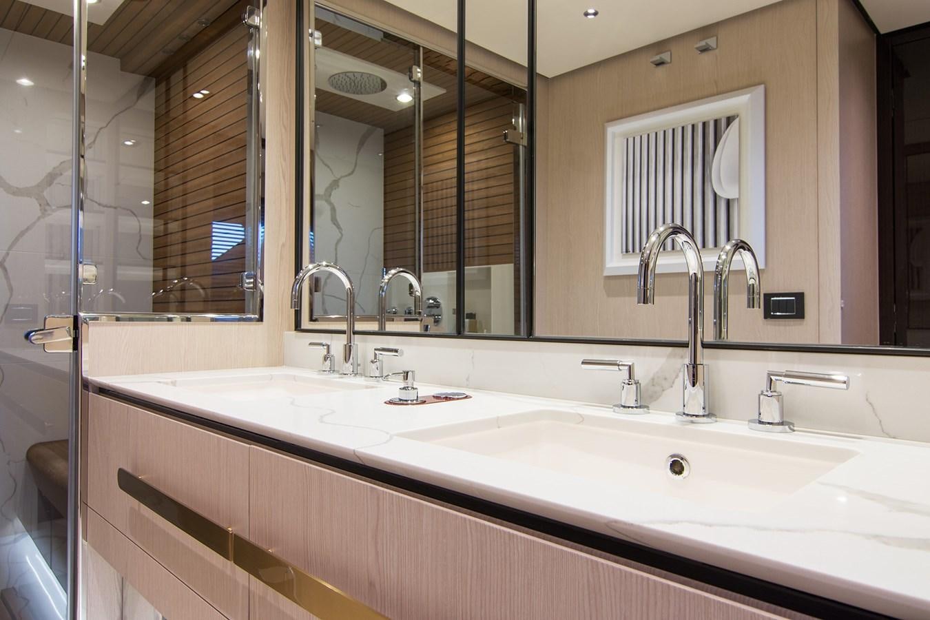 a bathroom with a large mirror aboard GDL Yacht for Sale