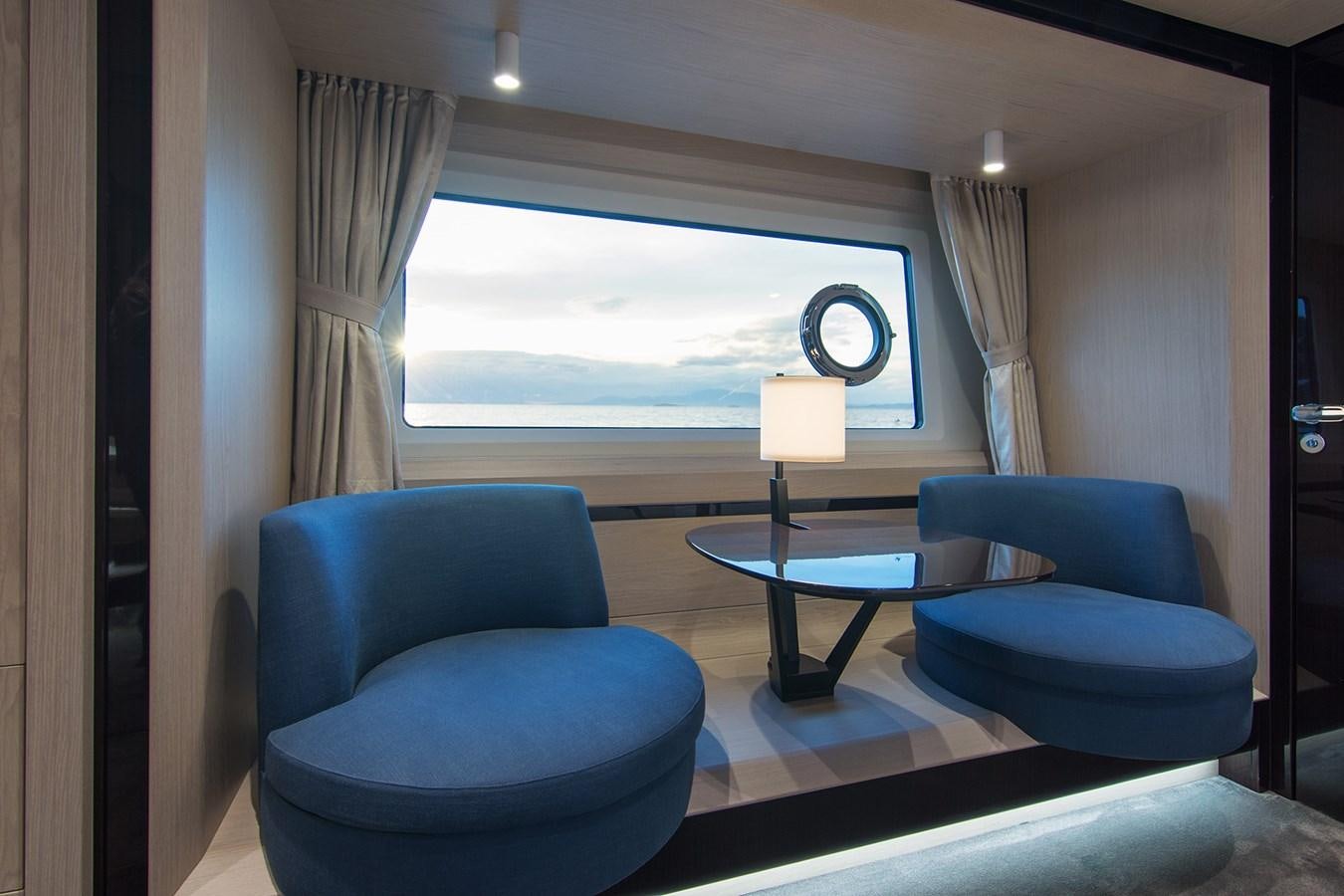 a room with a table and chairs aboard GDL Yacht for Sale
