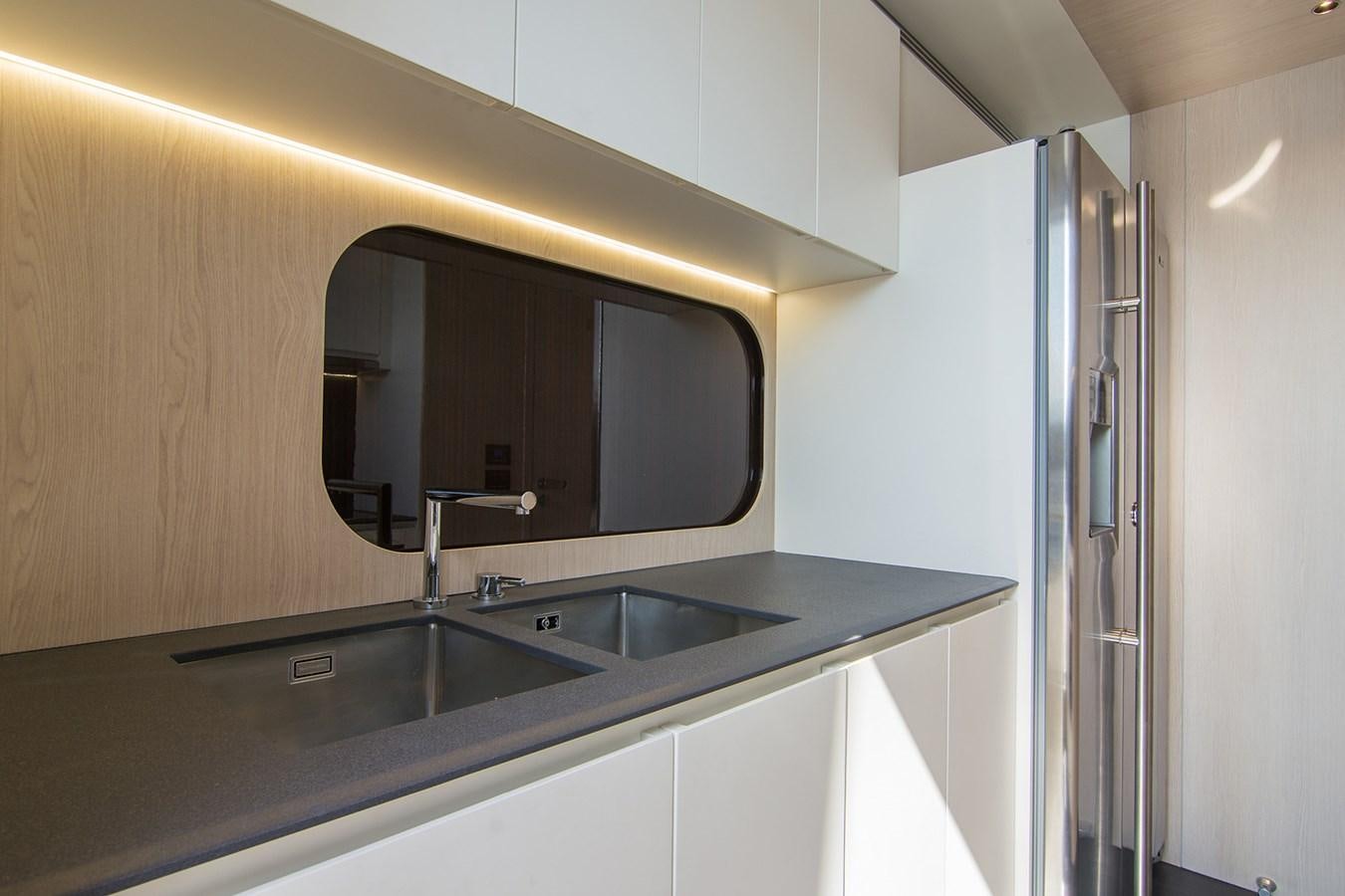 a kitchen with a sink and a mirror aboard GDL Yacht for Sale