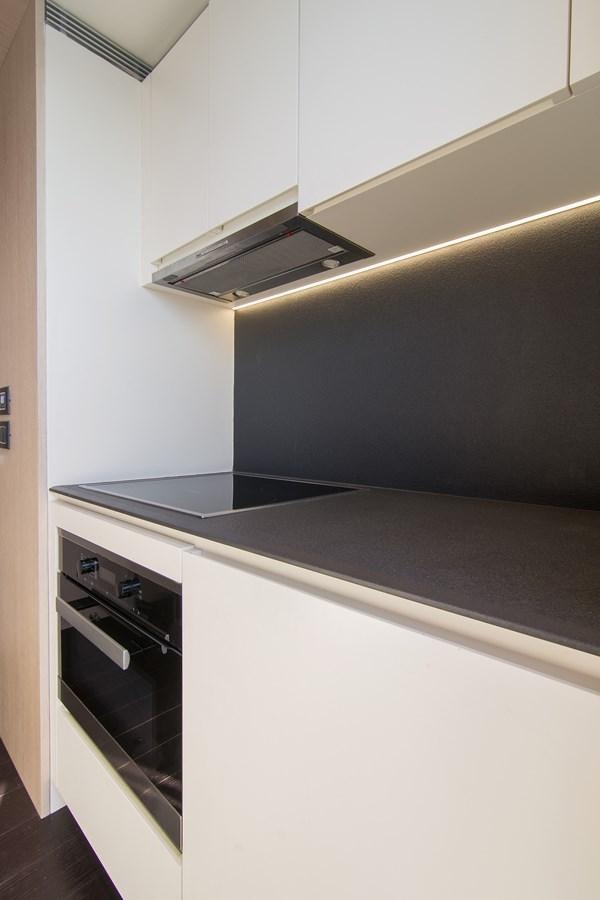 a kitchen with a steel stove aboard GDL Yacht for Sale