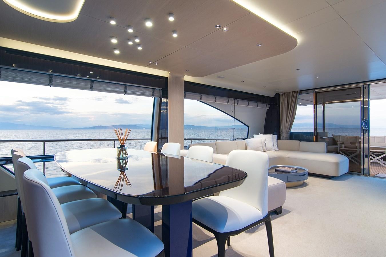 a room with a table and chairs aboard GDL Yacht for Sale