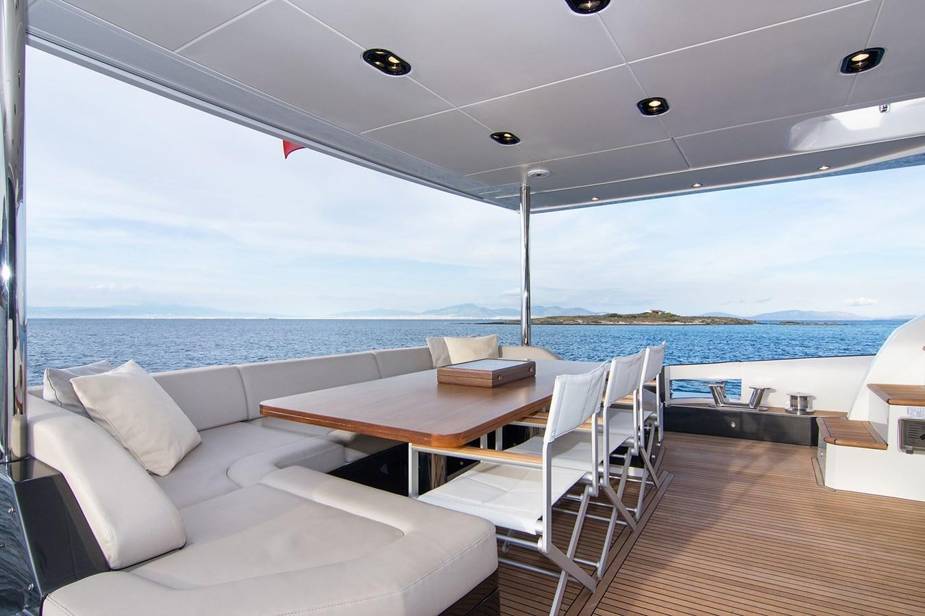 a room with a table and chairs aboard GDL Yacht for Sale