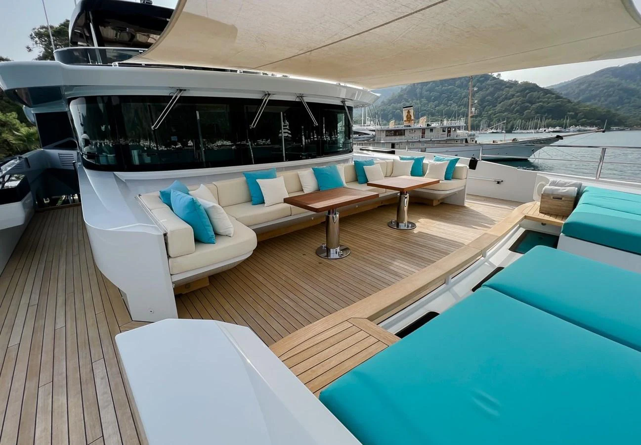 a deck with a pool and a deck with a view of the mountains aboard UNASOLA Yacht for Sale