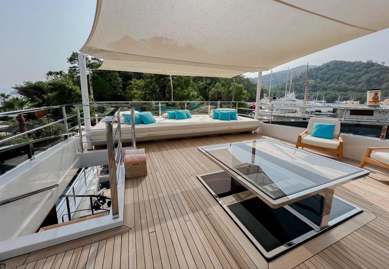 a deck with a pool and a deck with a view of the water aboard UNASOLA Yacht for Sale