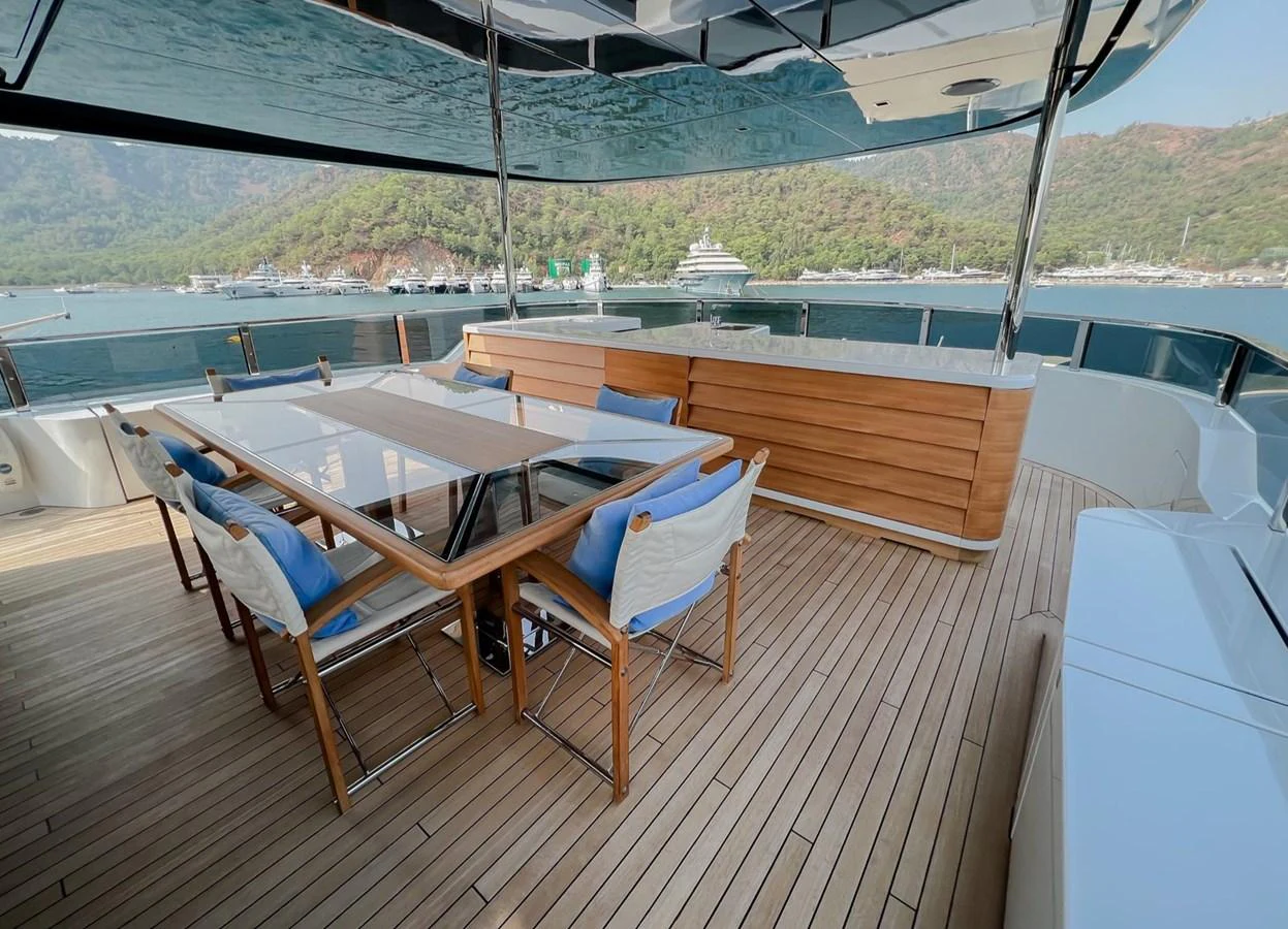 a deck with chairs and tables on it aboard UNASOLA Yacht for Sale