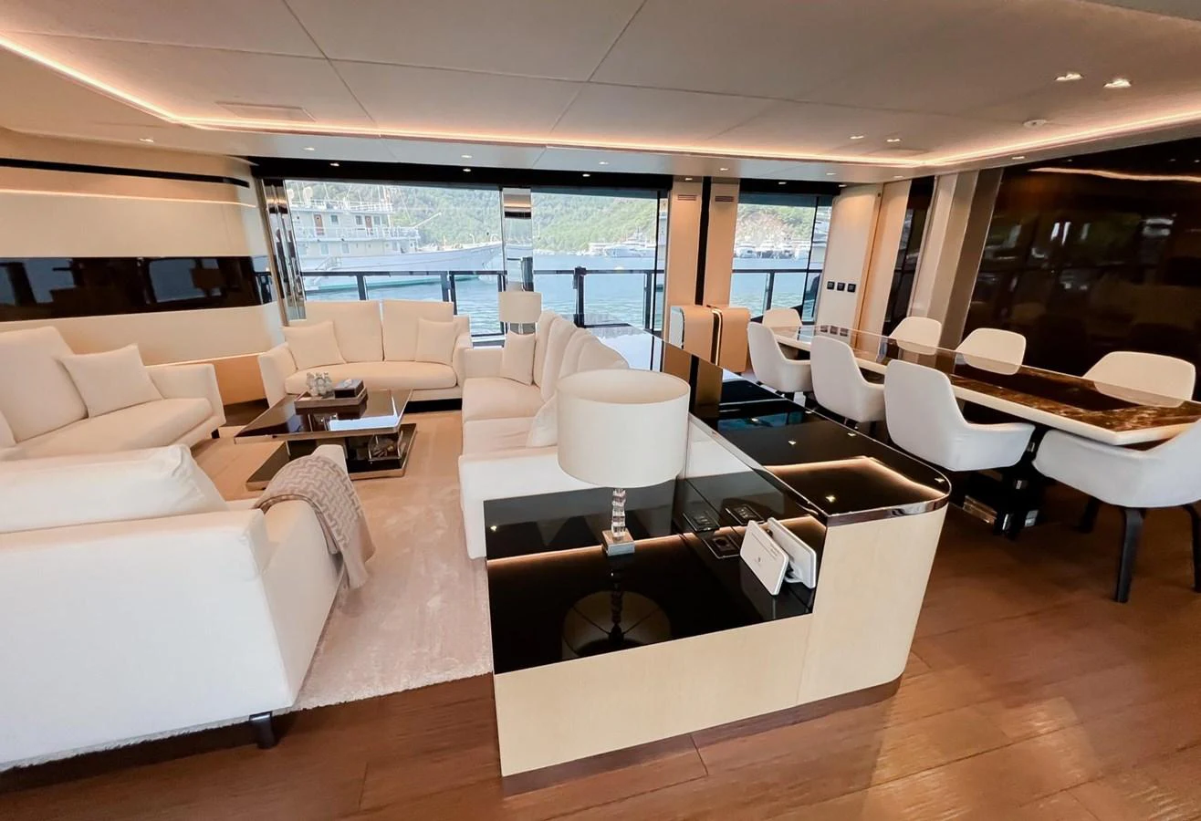 a room with a couch and a table with chairs aboard UNASOLA Yacht for Sale