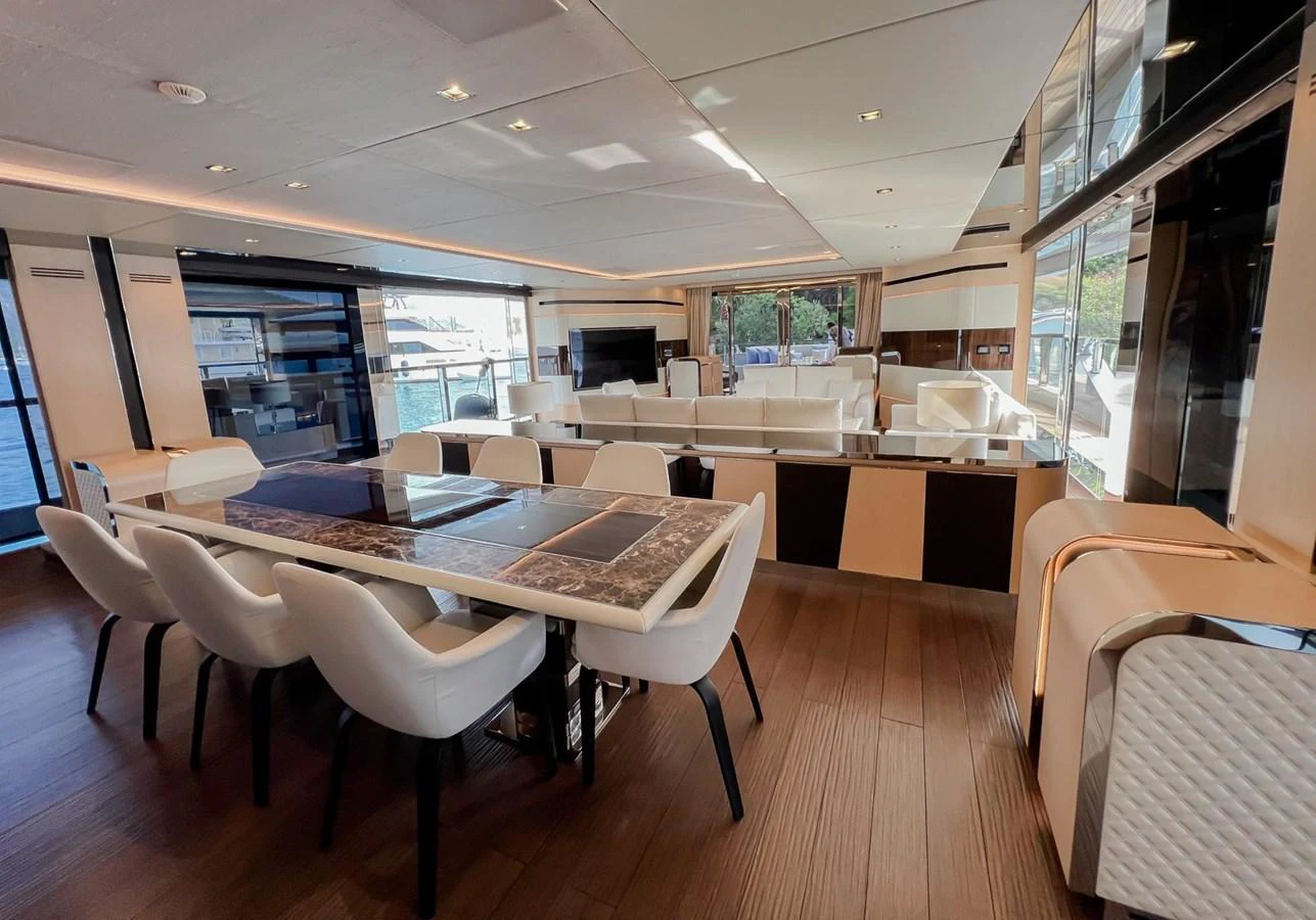 a room with tables and chairs aboard UNASOLA Yacht for Sale
