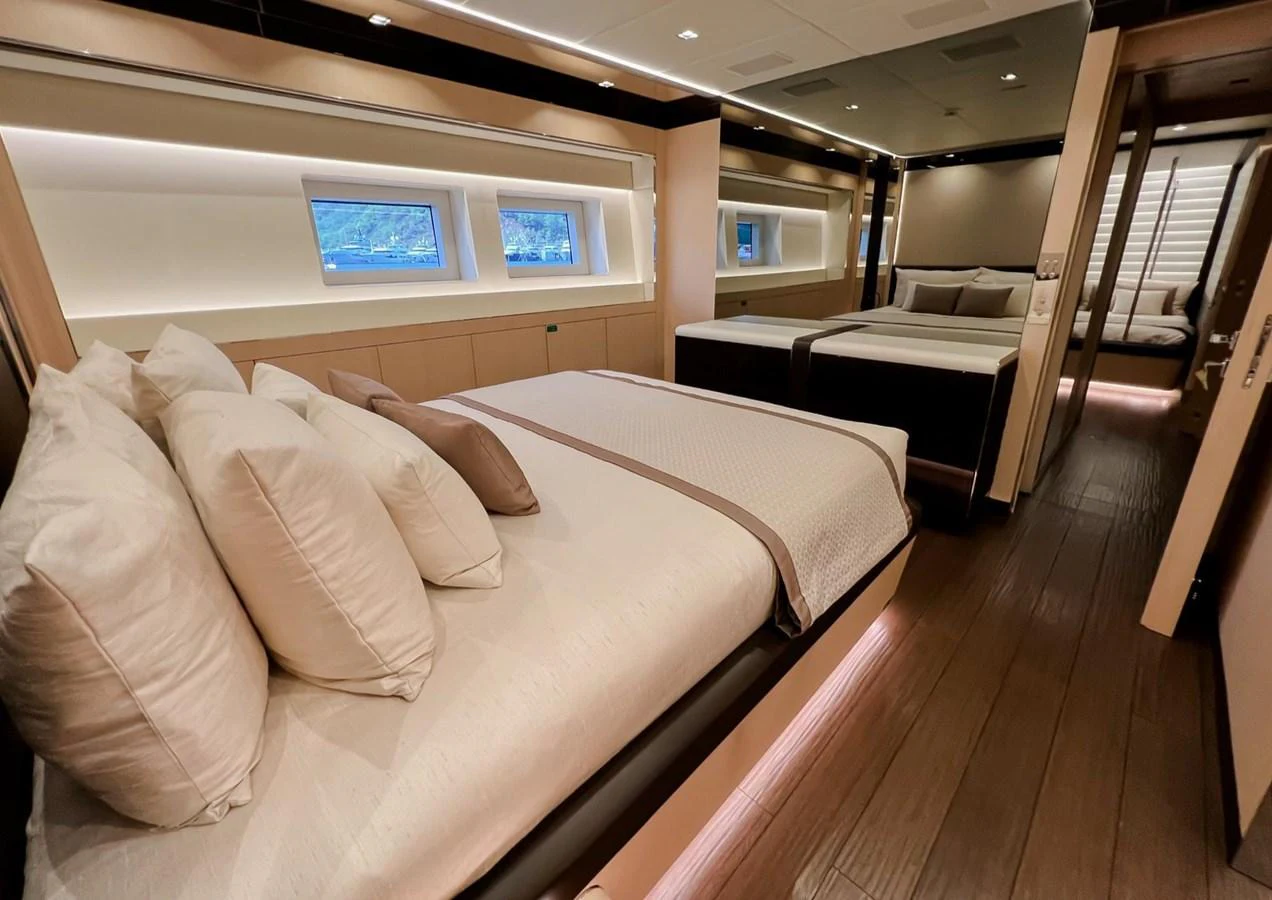 a room with a bed and a tv on the wall aboard UNASOLA Yacht for Sale