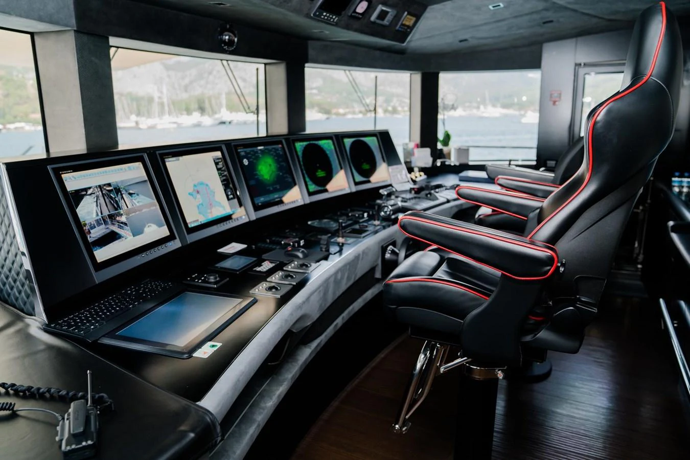 a room with many monitors and keyboards aboard UNASOLA Yacht for Sale
