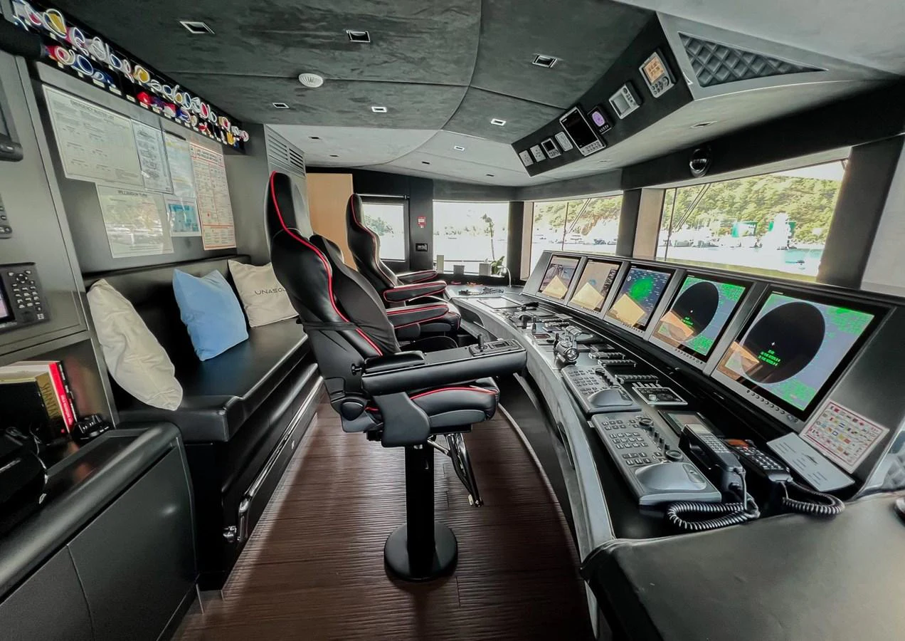 a room with a desk and chairs aboard UNASOLA Yacht for Sale