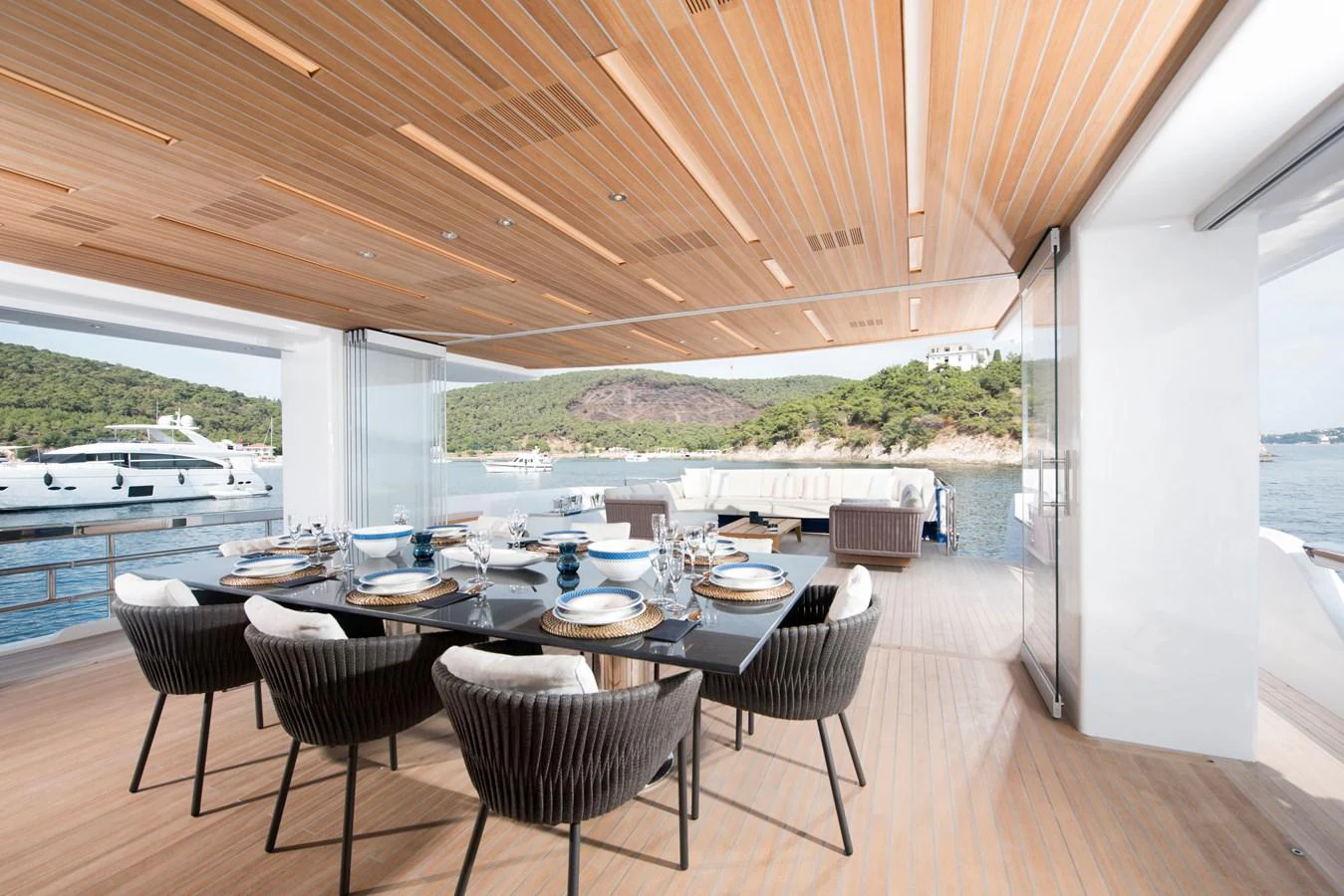 a large patio with tables and chairs aboard PICCOLO @ FLIBS Yacht for Sale