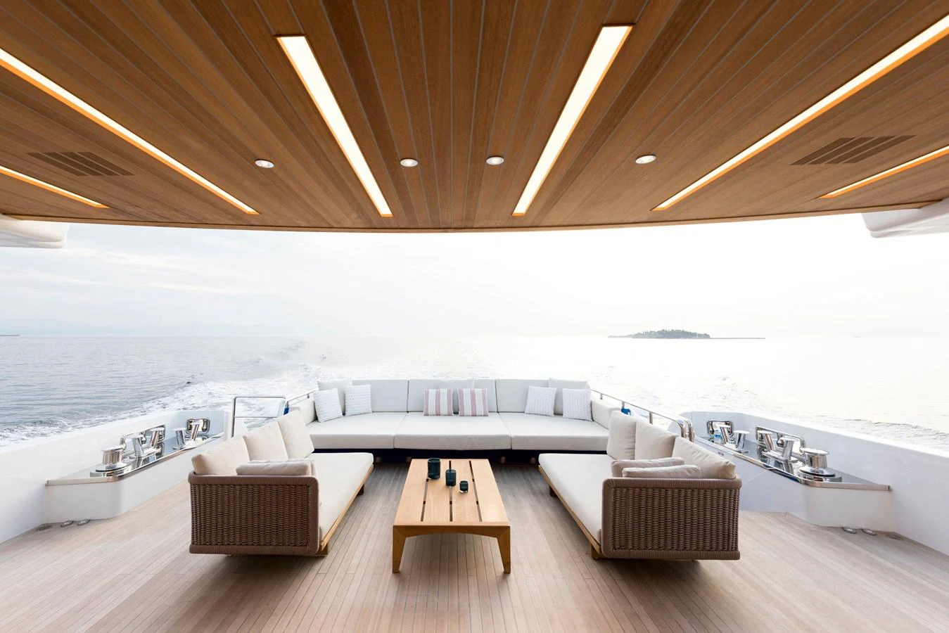 a room with a couch and a table and a view of the ocean aboard PICCOLO @ FLIBS Yacht for Sale