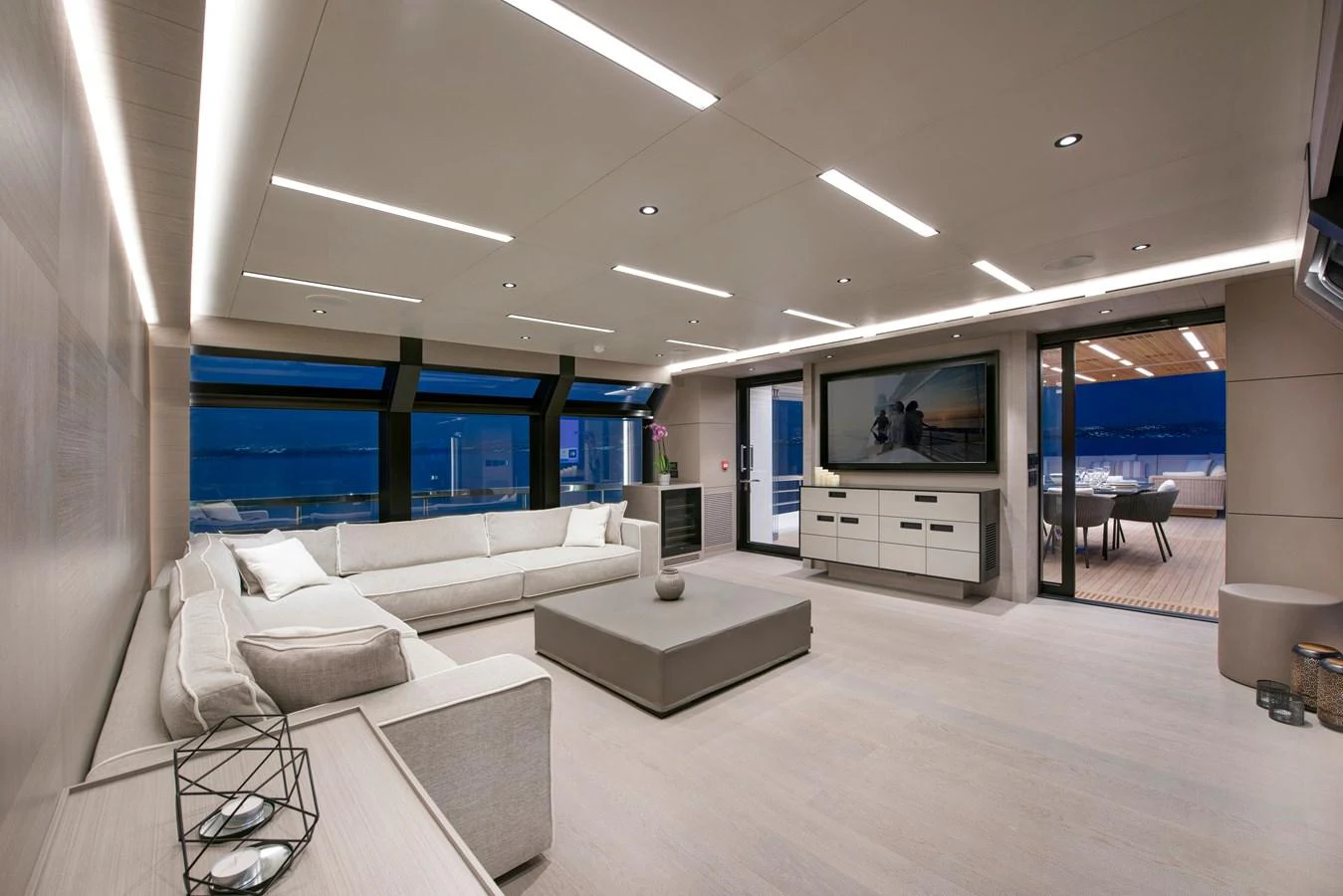 a room with a couch and a television aboard PICCOLO @ FLIBS Yacht for Sale