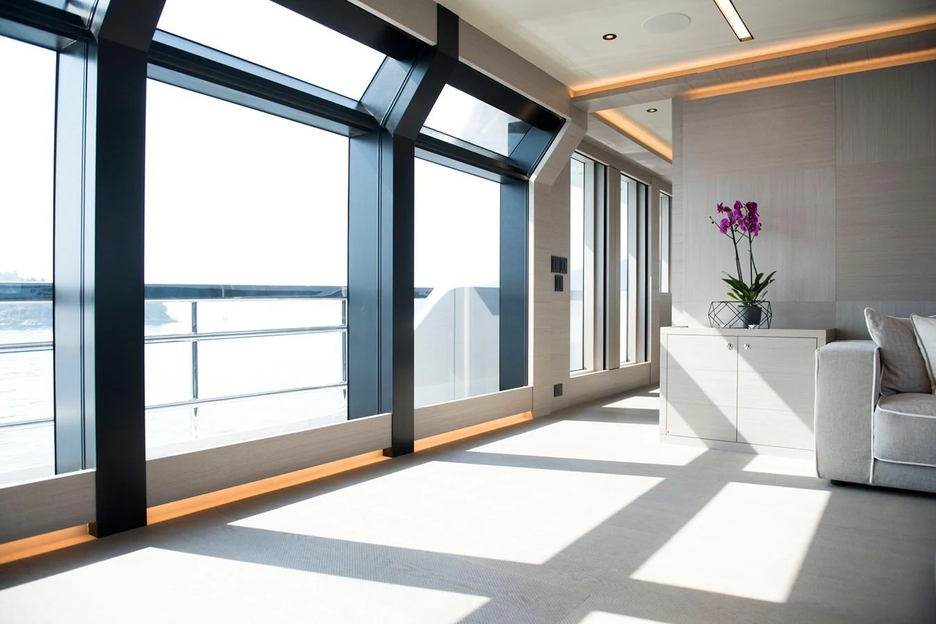 a room with a large window and a couch aboard PICCOLO @ FLIBS Yacht for Sale