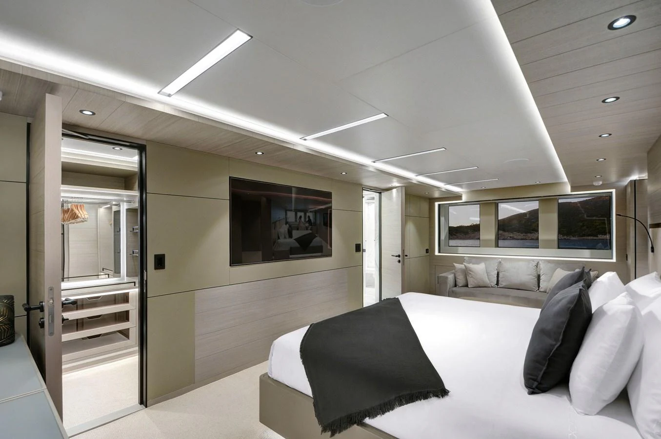 a room with a bed and a television aboard PICCOLO @ FLIBS Yacht for Sale
