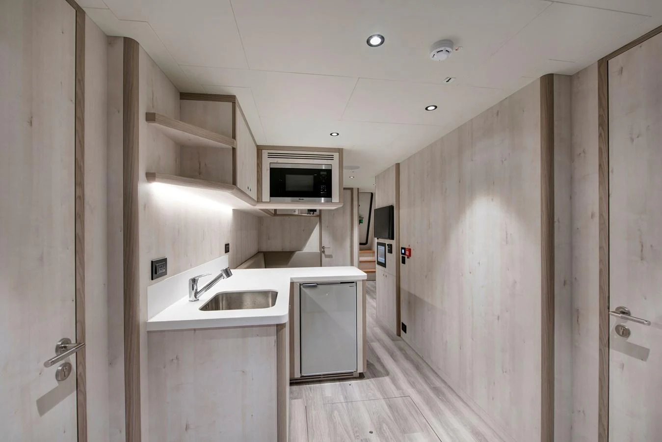 a kitchen with white cabinets aboard PICCOLO @ FLIBS Yacht for Sale