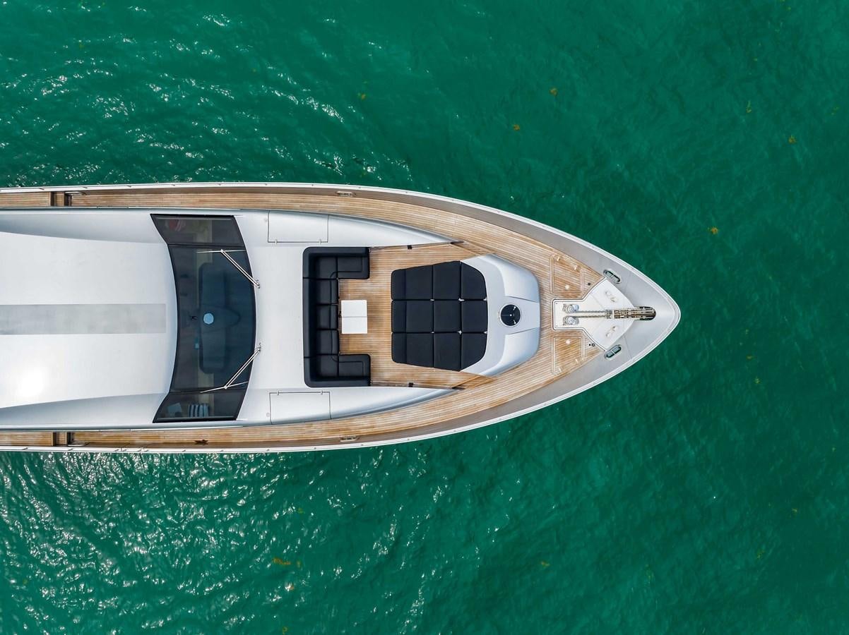 a white boat on a body of water aboard ARENA Yacht for Sale