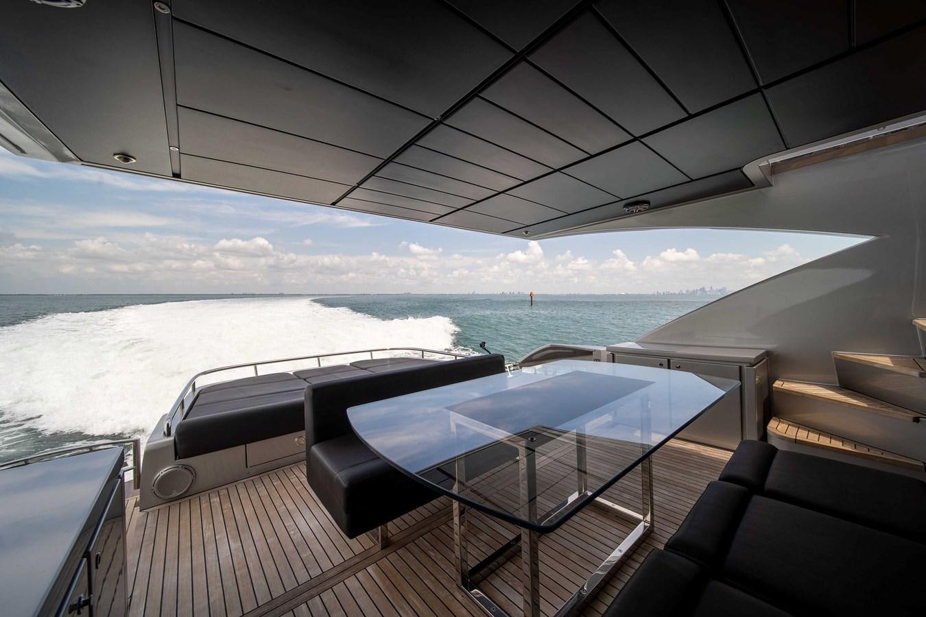 a table and chairs on a deck aboard ARENA Yacht for Sale