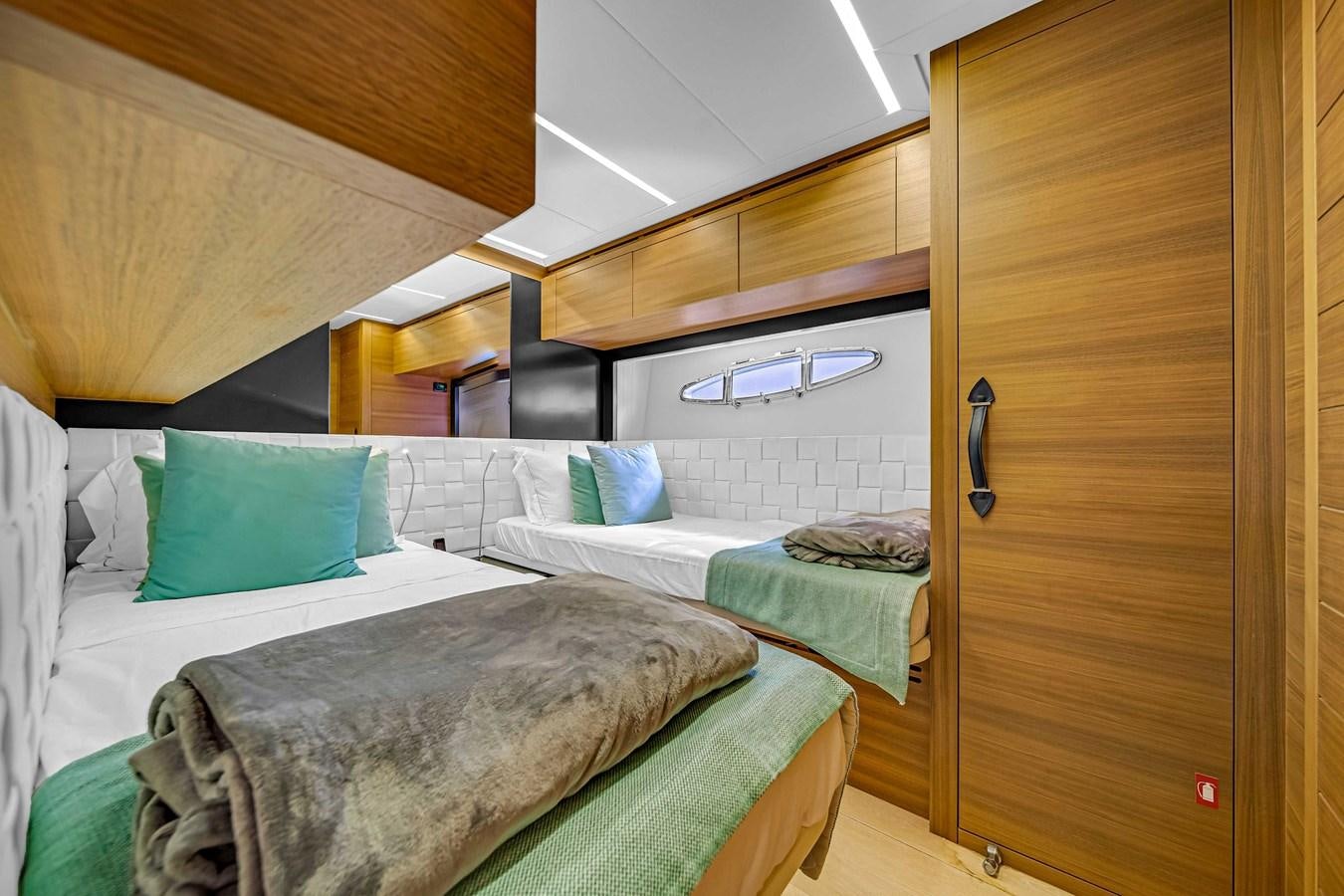a room with two beds aboard ARENA Yacht for Sale