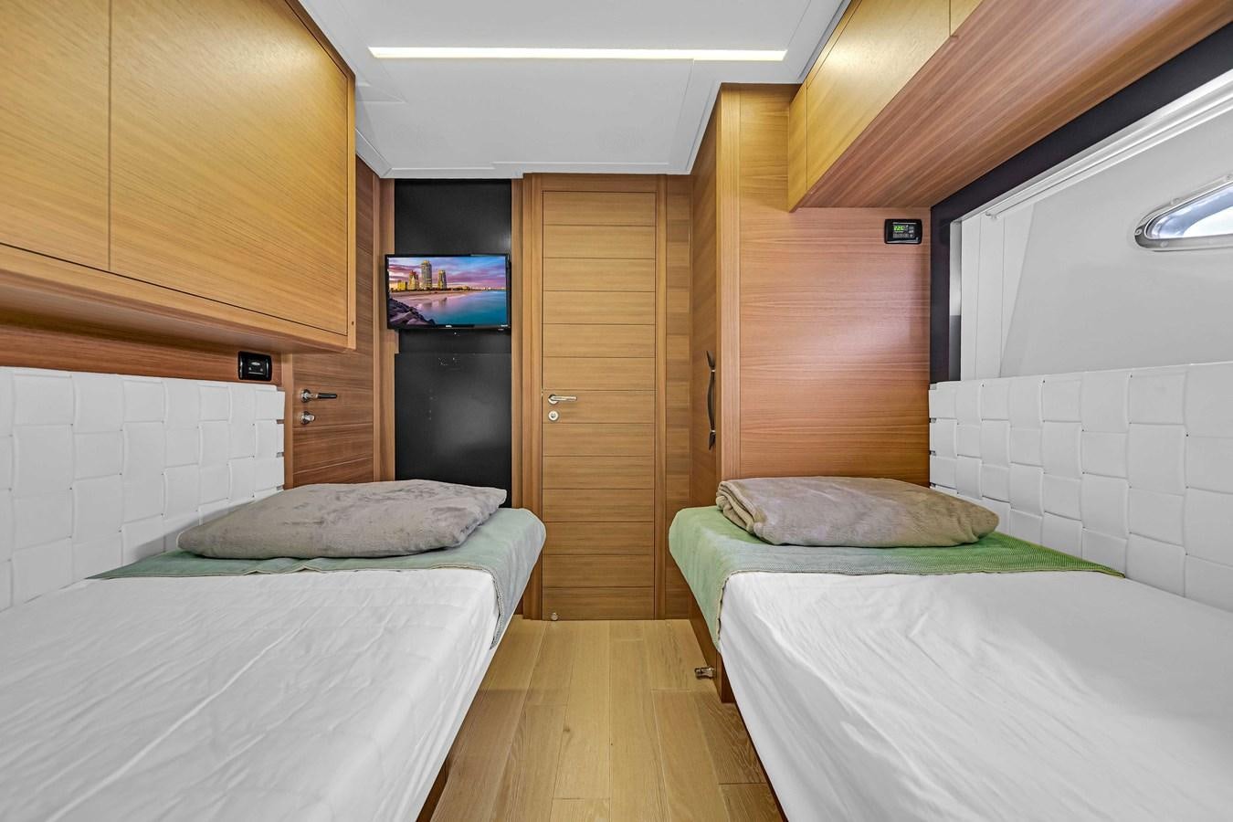 a room with beds and a tv aboard ARENA Yacht for Sale
