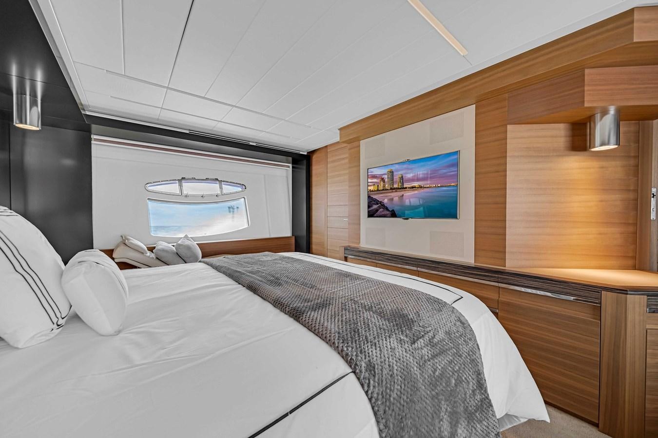a room with a bed and a television aboard ARENA Yacht for Sale
