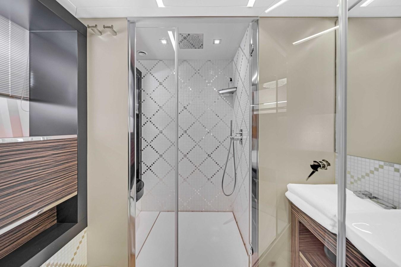 a bathroom with a shower unit and sink aboard ARENA Yacht for Sale