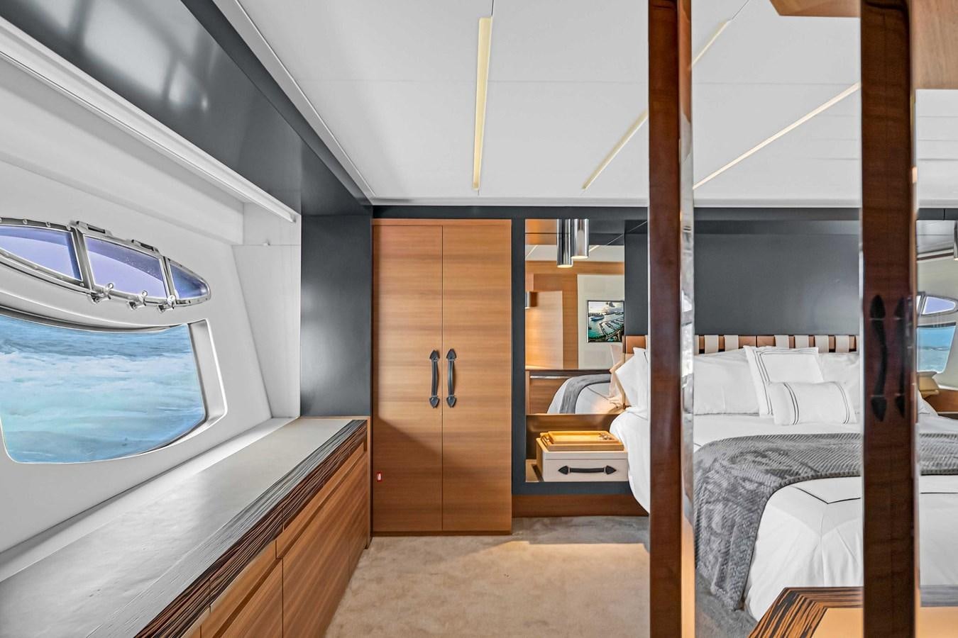a room with a bed and a door aboard ARENA Yacht for Sale