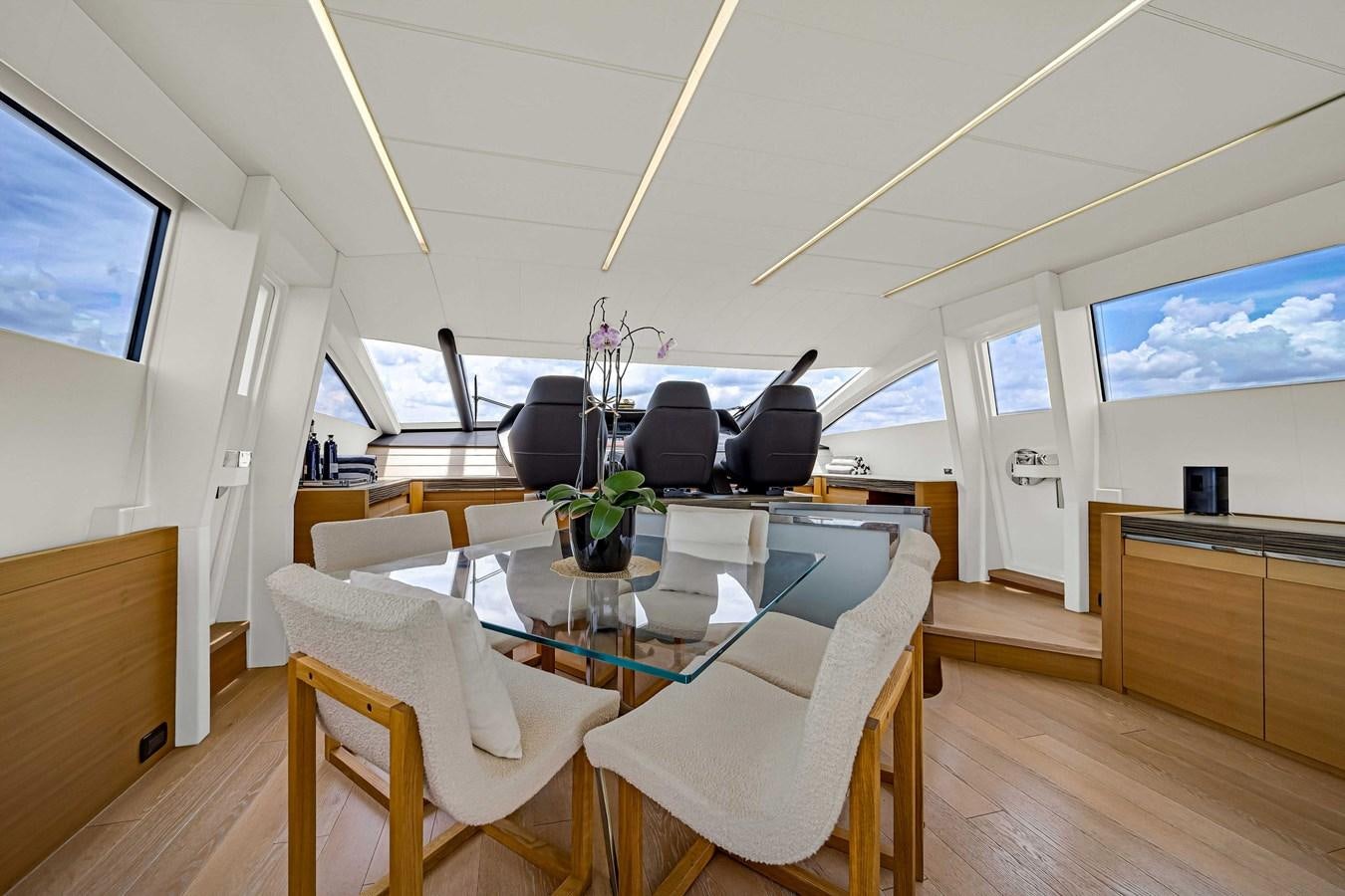 a room with a table and chairs aboard ARENA Yacht for Sale