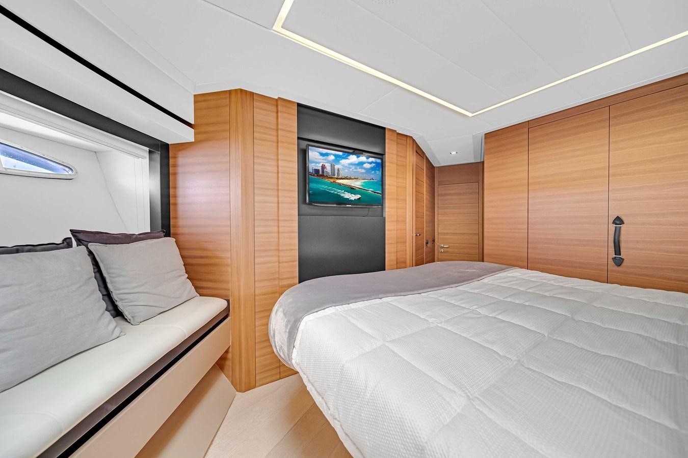 a room with a bed and a tv aboard ARENA Yacht for Sale