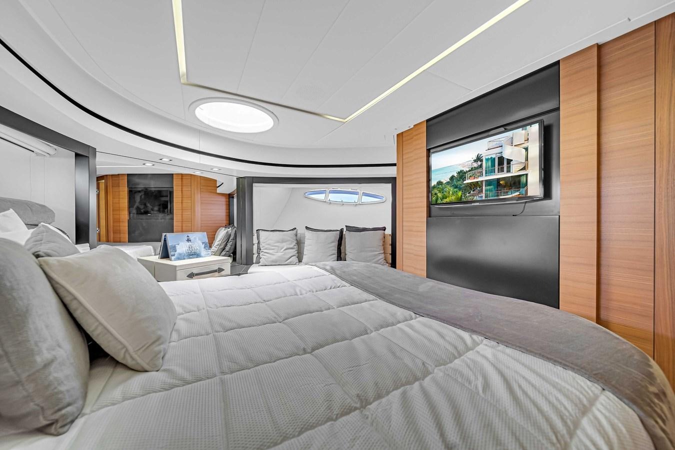 a bed with a white bed spread aboard ARENA Yacht for Sale
