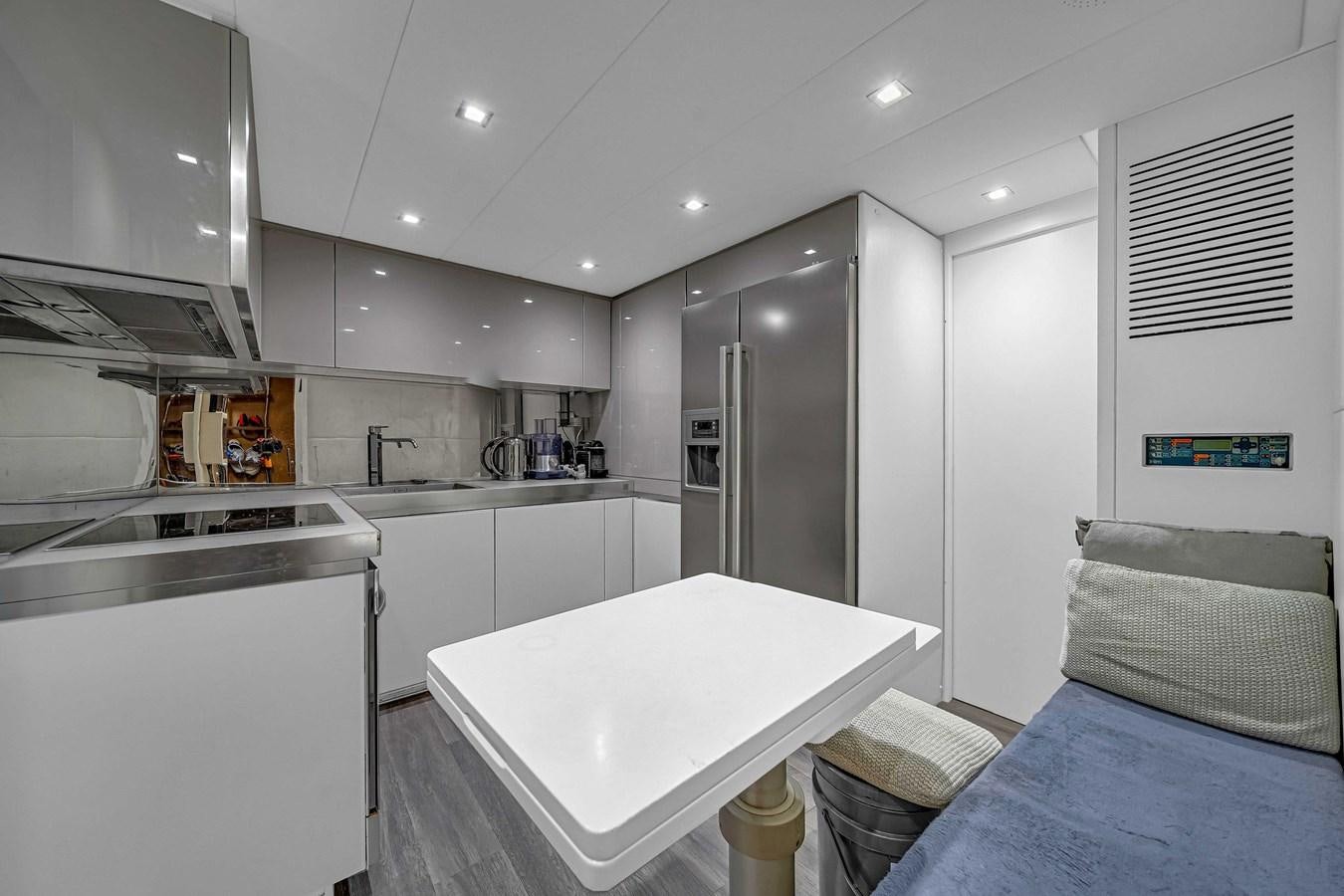 a small kitchen with a bed aboard ARENA Yacht for Sale