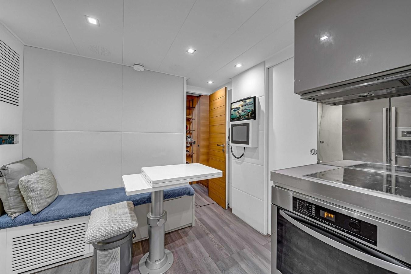 a kitchen with a couch and a table aboard ARENA Yacht for Sale
