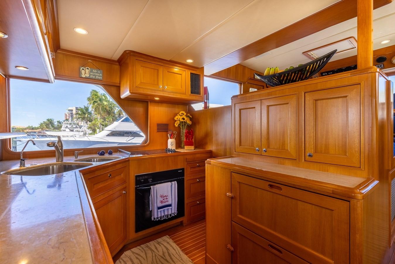 a kitchen with wooden cabinets aboard SUNSHINE Yacht for Sale