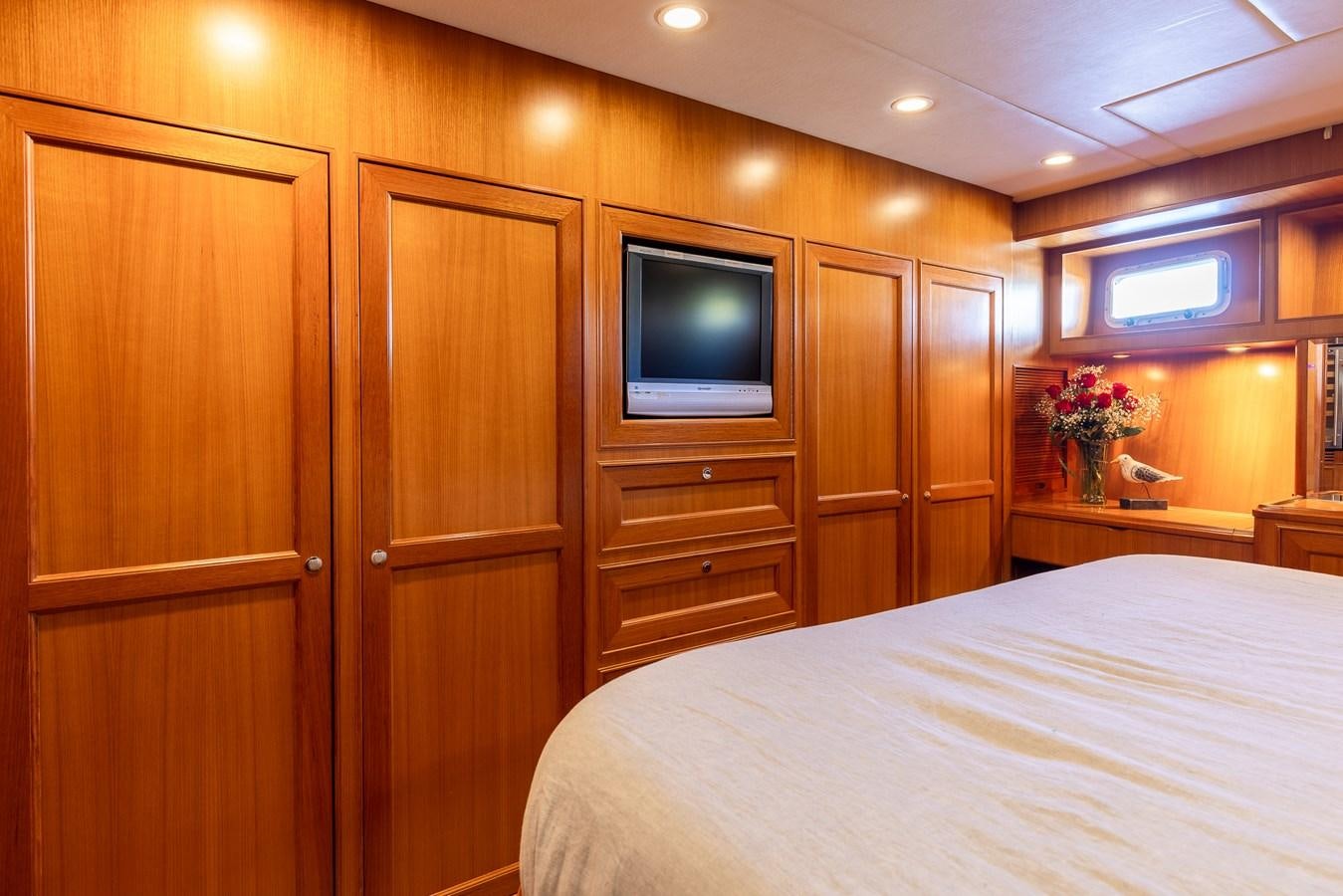 a bedroom with a bed and a television aboard SUNSHINE Yacht for Sale